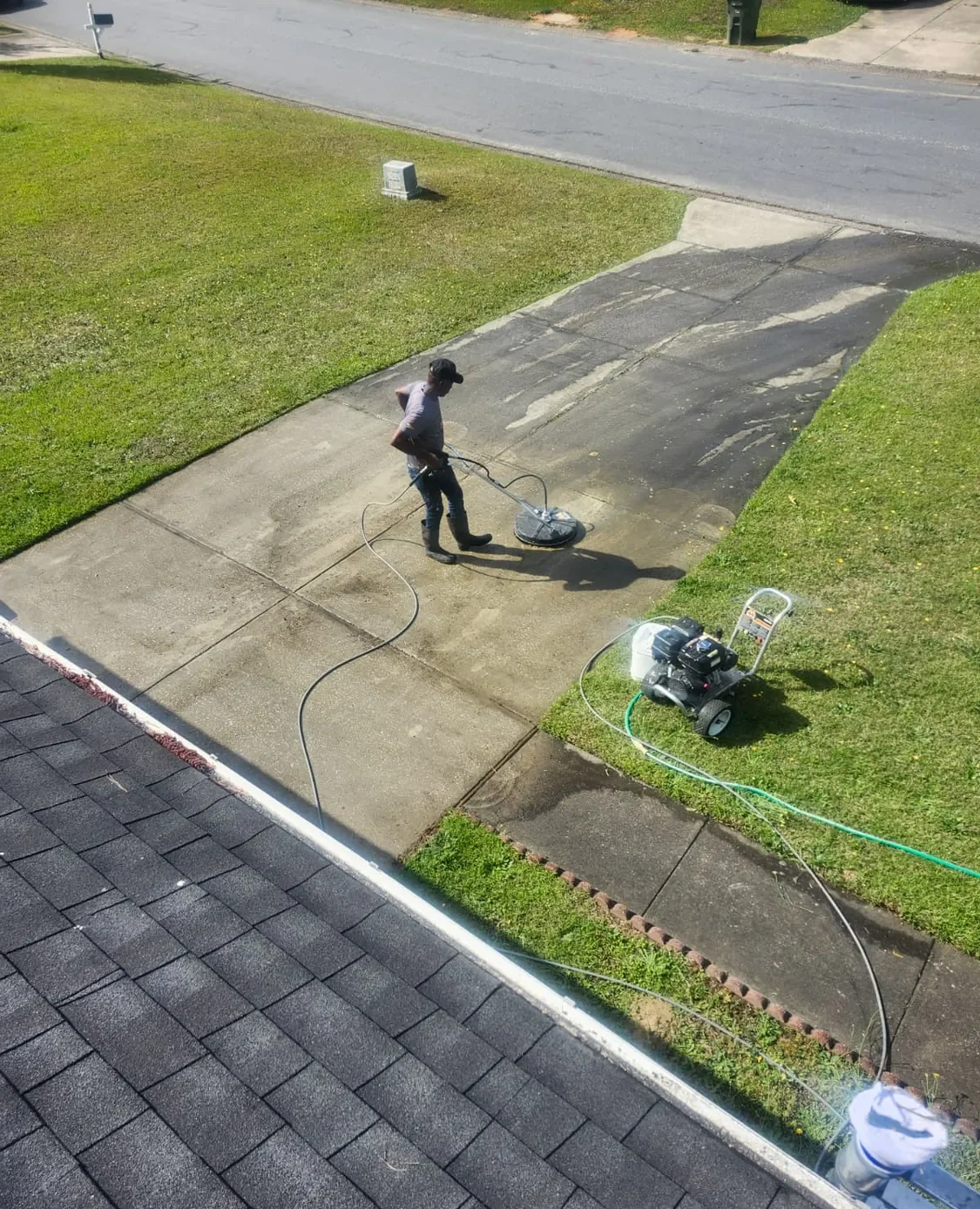 Surface cleaner taking the grime off a concrete driveway